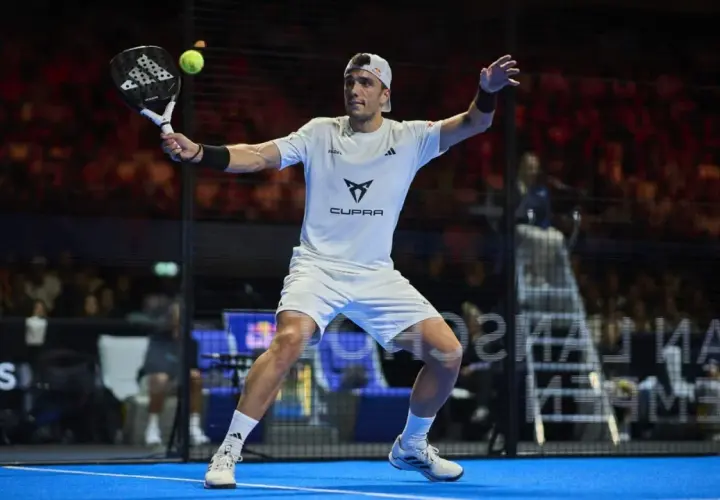Il giocatore di padel, con abbigliamento adidas, colpisce la palla. È un momento di gioco intenso per adidas Ale Galan.