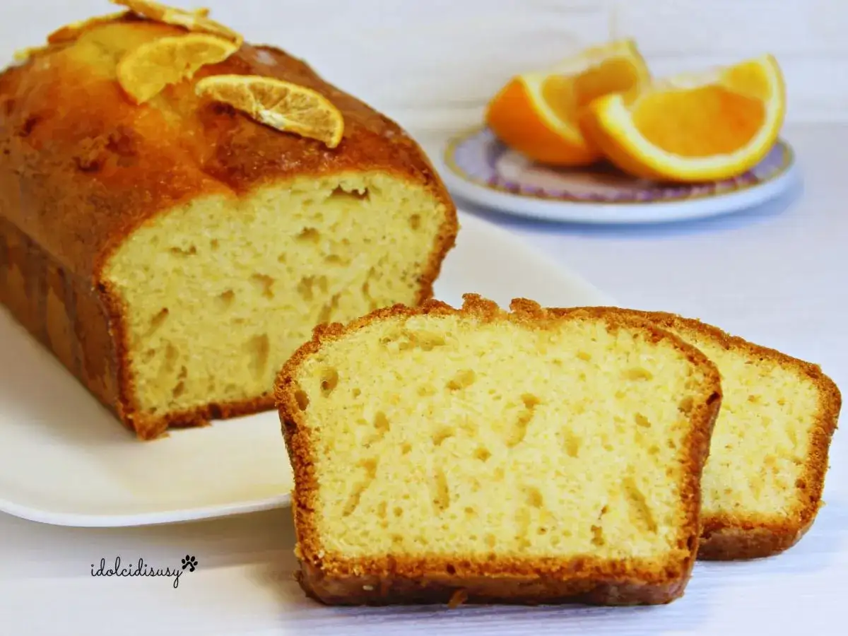 Delizioso plumcake senza uova, soffice e dorato, decorato con fettine d'arancia. Perfetto per la colazione o la merenda.